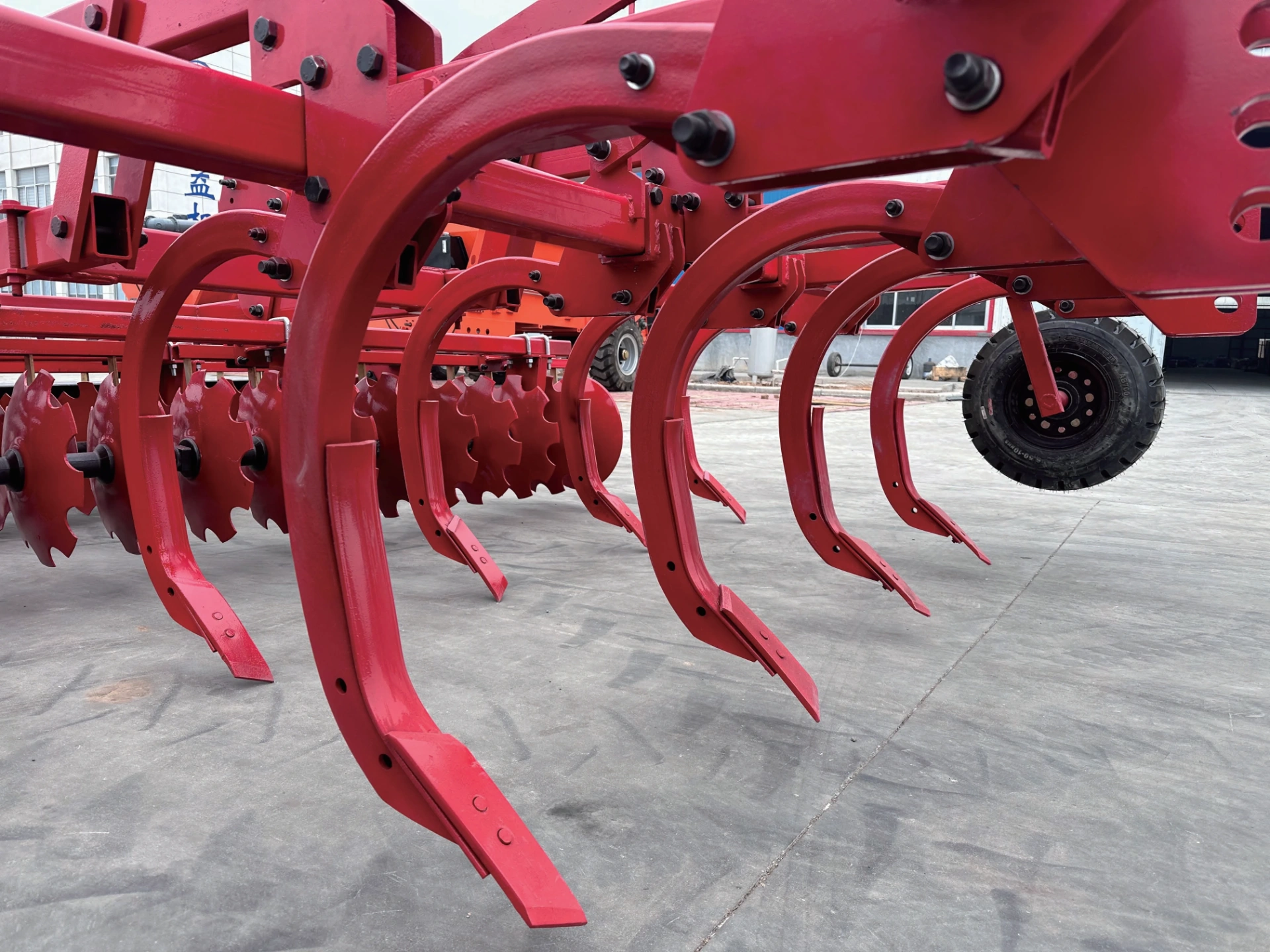 Subsoiling Combined Land Preparation Machine - Full Product Description This Subsoiling Combined Land Preparation Machine is a high-end compound tillage equipment purpose-built for breaking plow pan and deep soil improvement. It provides standard working width options from 2.5m to 3.45m, compatible with tractors above 120HP. It integrates two processes of deep subsoiling and topsoil leveling into one single machine, completely solves the industry pain points of hard plow pan and poor soil permeability caused by years of continuous rotary tillage, and serves as the flagship equipment for conservation tillage on high-standard farmland. Front Subsoiler + Rear Harrow Design, Finish Subsoiling & Tillage in One Pass The front part of the machine is equipped with high-strength subsoiler shanks, which can directly penetrate 350-450mm underground and completely break the hard plow pan formed by years of farming. The rear part is matched with 460mm high wear-resistant disc harrow group, which completes topsoil crushing and leveling simultaneously. It finishes both subsoiling and tillage in one field entry, eliminates the problem that extra large soil clods are left after subsoiling which requires secondary tillage, and drastically saves operation time and fuel cost. Thickened Heavy-Duty Structure with Ultra-High Reliability The main girder of the whole machine is integrally welded with 100mm100mm8mm thickened square steel tube. All connection points of subsoiler shanks and discs are reinforced for heavy load. Even under long-term full load operation on compacted hard plots and stony fields, there will be no shank deformation or frame crack, the overall durability is far better than ordinary subsoiling equipment. Multiple Precise Models to Meet Different Operation Demands The 3 models of the full series are equipped with 7, 9 and 11 subsoiler shanks respectively, the working width increases gradually from 2.5m to 3.45m, which accurately matches high-horsepower tractors in different power segments of 120-180HP and above 200HP. The subsoiler shanks are arranged with reasonable spacing, which forms uniform loose layer underground after operation without subsoiling blind spots, the soil permeability and water permeability are greatly improved, and the moisture retention and drought resistance performance is remarkable. Conservation Tillage Helps Long-Term Yield Increase Subsoiling operation does not turn over the soil layer and will not disturb the original soil tillage structure. It also mixes crop stubble and organic fertilizer into deep soil better to continuously improve soil fertility. After operation, rainwater infiltration speed increases several times, and soil water retention capacity is greatly enhanced in dry seasons. After 2-3 consecutive years of use, you can clearly observe that crop roots grow deeper, drought resistance and lodging resistance are improved, and it delivers remarkable long-term stable yield and yield increase effect. Typical Applications: Subsoiling conservation tillage in northeast China black soil region, plow pan breaking on years of rotary tilled fields, moisture retention tillage in arid and semi-arid areas, deep soil improvement for high-standard farmland, and farmland soil fertility restoration operations for large-scale farms.